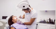 dentist-examining-female-patient-teeth